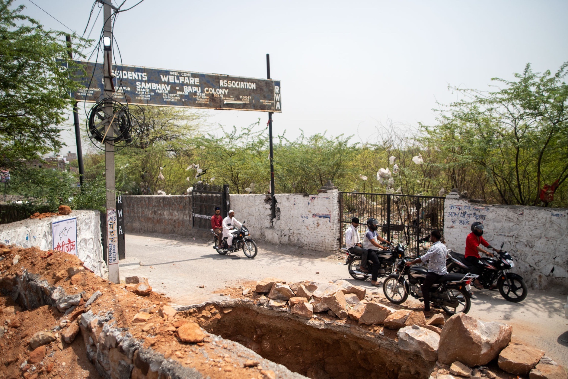Entrance to the Bapu Colony in the south of New Delhi showing a lot of motor bikes and construction work